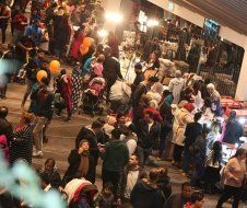 A large group of people are standing in a room.