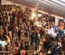 A large crowd of people are gathered in a large room.