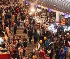 A large crowd of people are gathered at a market.