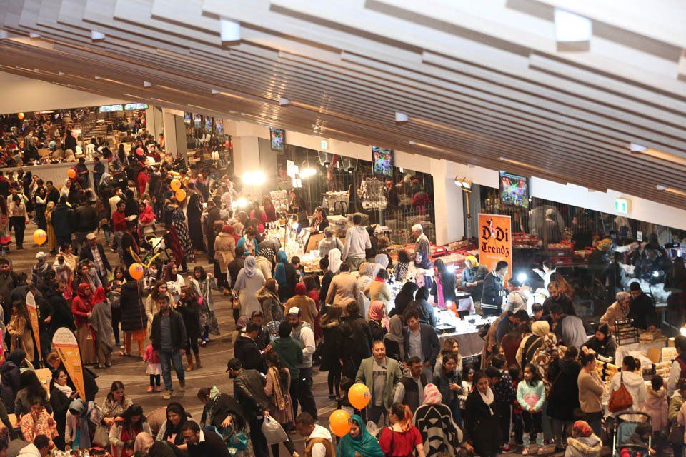 A large crowd of people are gathered in a building.