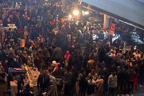 A large crowd of people are gathered in a room.