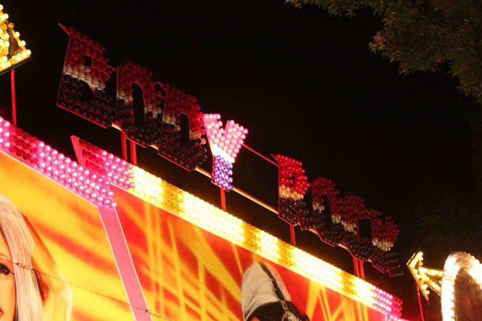 A close up of a carnival ride that says party bus