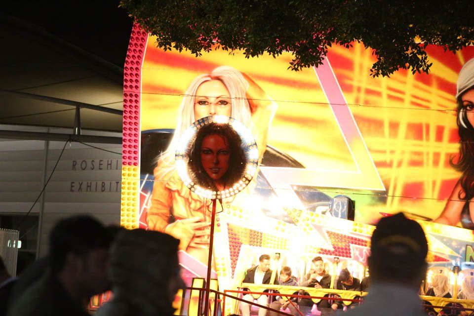 A group of people are standing in front of a robert exhibit sign
