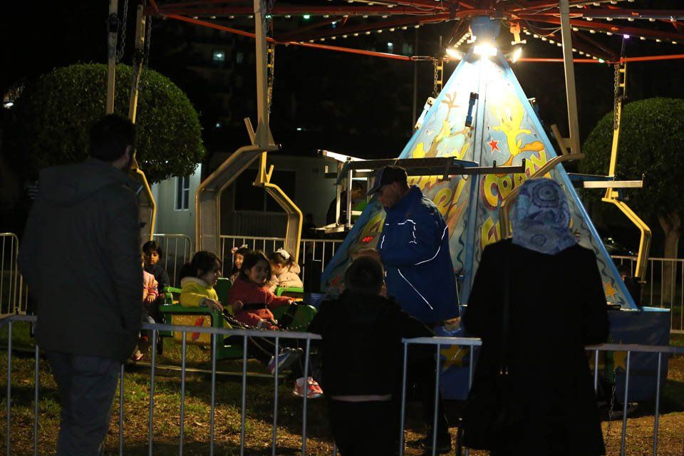 A group of people are riding a ferris wheel at night