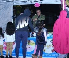 A group of people are standing in front of a tent.