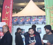A group of men are standing in front of a tent.