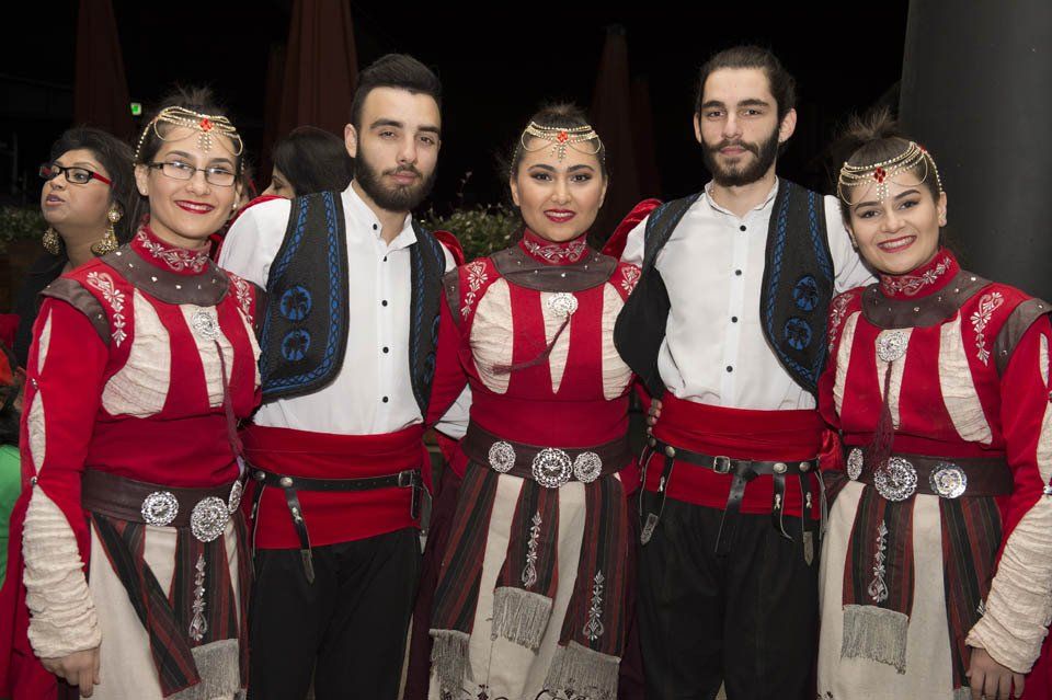 A group of people in traditional costume are posing for a picture.