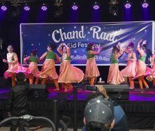 A group of young girls are dancing on a stage.