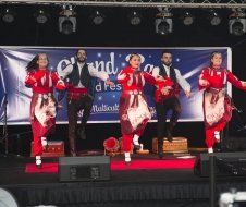 A group of people are dancing on a stage.
