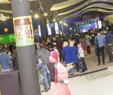 A large group of people are standing in a room.