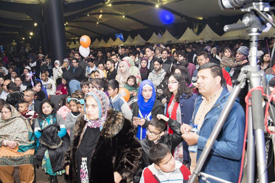 A large crowd of people are gathered in a large room.