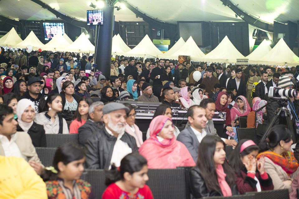 A large group of people are sitting in a large room.