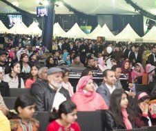 A large group of people are sitting in a large room.