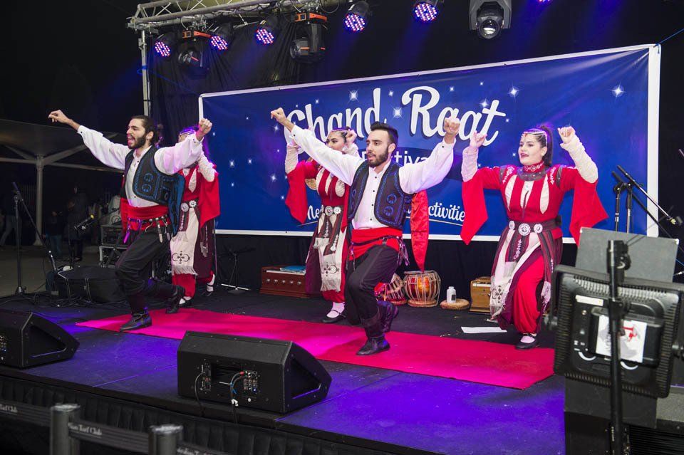 A group of people are dancing on a stage.
