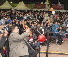 A crowd of people are sitting in a stadium watching a performance.