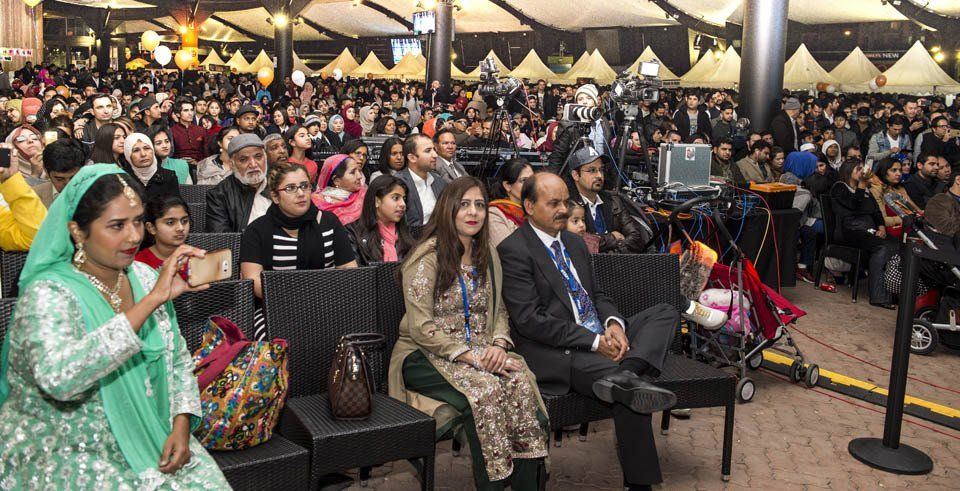 A large group of people are sitting in chairs in a room.