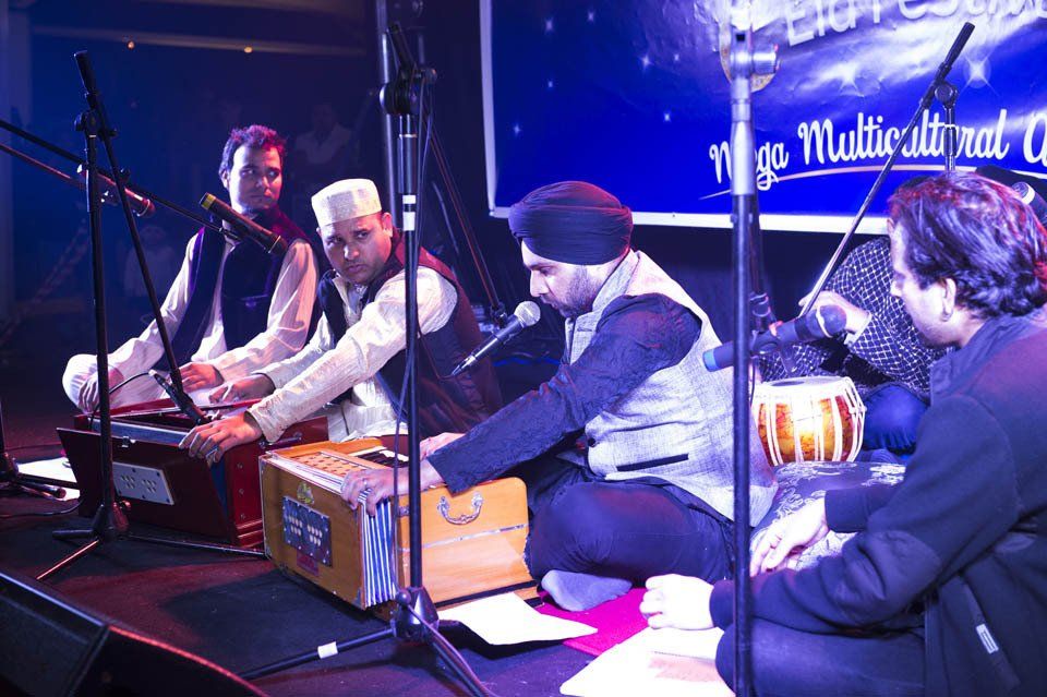 A group of men are playing instruments on a stage.
