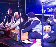 A group of men are playing instruments on a stage.