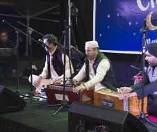A group of men are playing instruments on a stage.