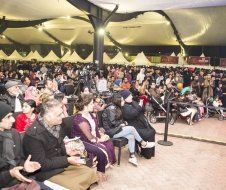 A large group of people are sitting in a large room.