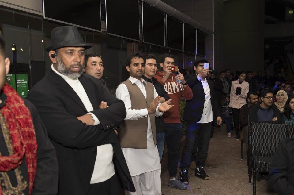 A group of people are standing in a line in a room.