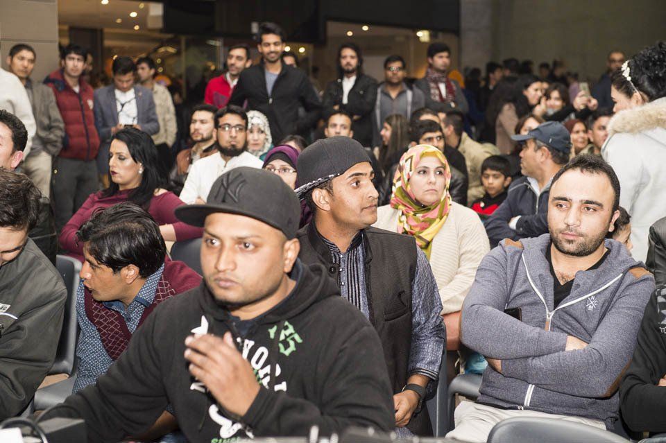 A group of people are sitting in chairs in a room.