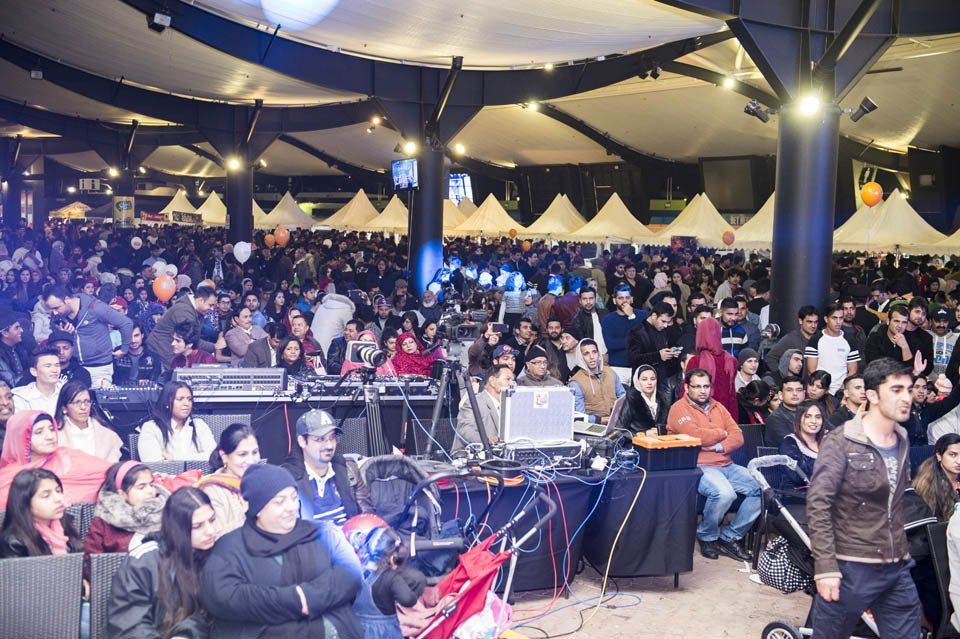 A large crowd of people are gathered in a large room