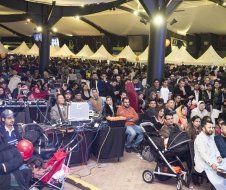 A large crowd of people are gathered in a large room.