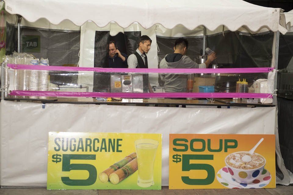 A food stand selling sugarcane and soup for 5 dollars