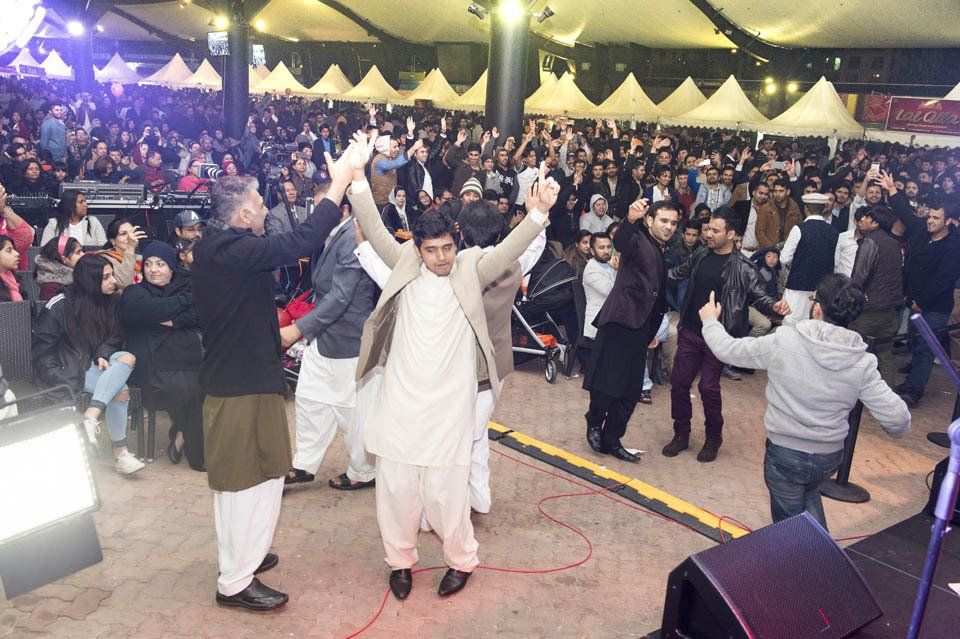 A group of people are dancing in front of a crowd