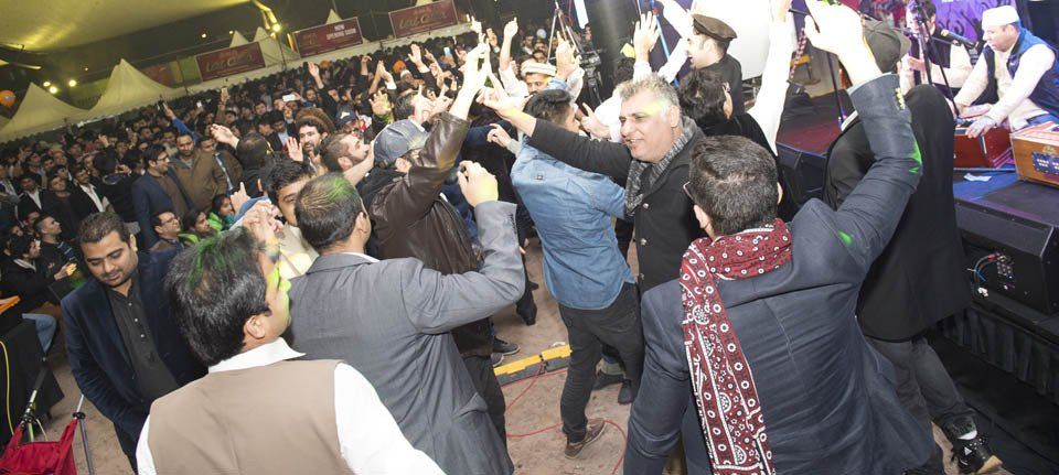 A large group of people are dancing at a party.