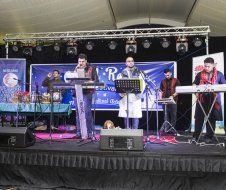 A group of people are playing instruments on a stage.