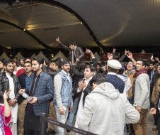 A group of people are standing in a room.