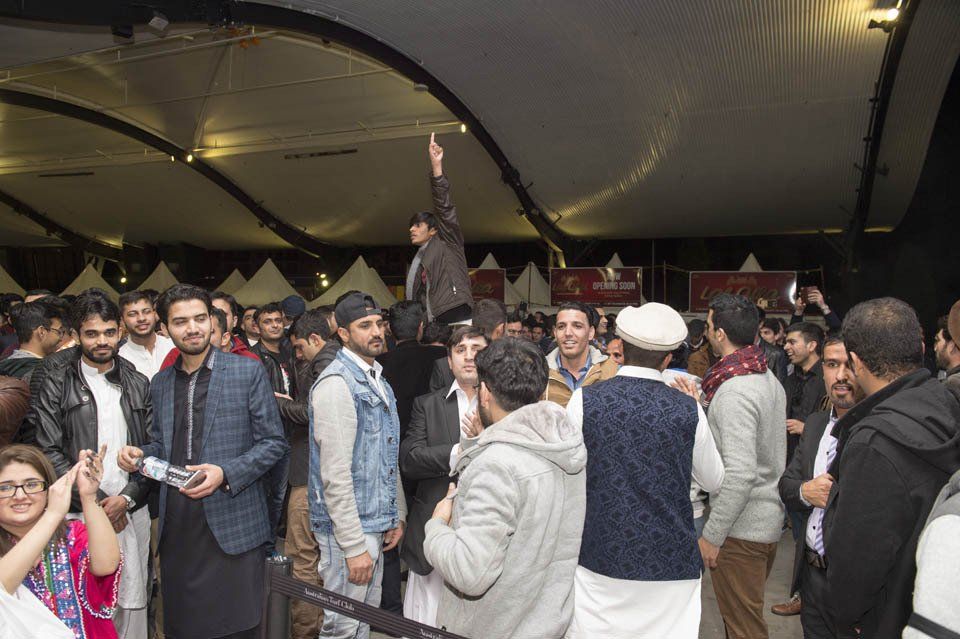 A group of people are standing in a room.