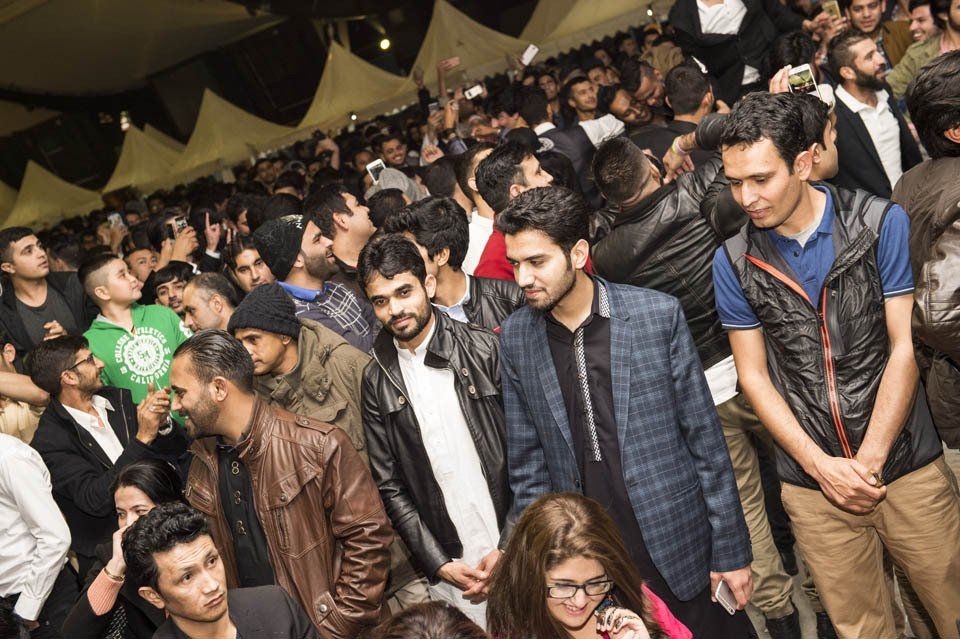 A crowd of people are standing in a room.