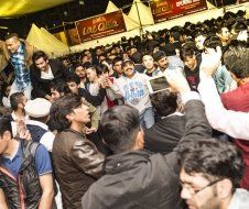 A large group of people are gathered in a crowd at a festival.