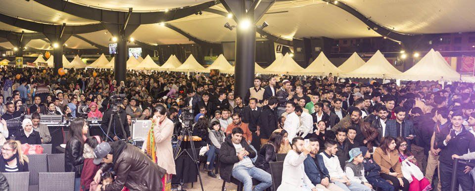 A large group of people are sitting in a large room.