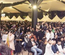 A large group of people are sitting in a room.