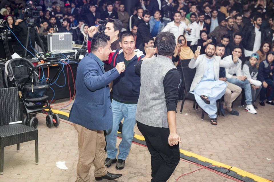 A group of people are dancing in front of a crowd.