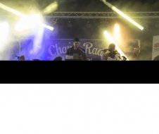 A man is singing into a microphone on a stage at a concert.