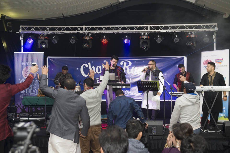A group of people are standing in front of a stage.