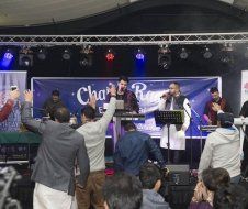 A group of people are standing in front of a stage.