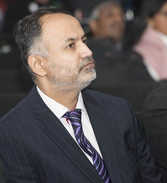 A man with a beard wearing a suit and tie