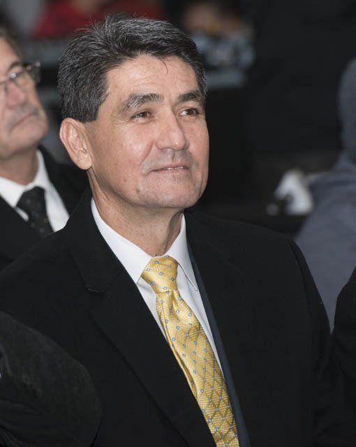 A man in a suit and tie stands in a crowd