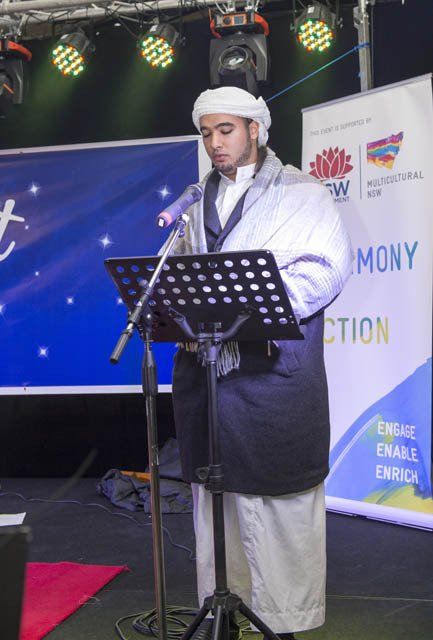 A man stands in front of a sign that says mony