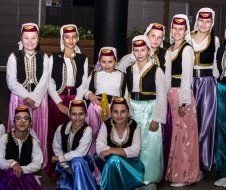 A group of children are posing for a picture in traditional costume.