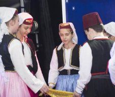 A group of people in traditional costumes are standing next to each other.