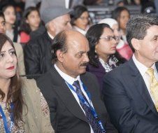 A group of people in suits and ties are sitting in a room.