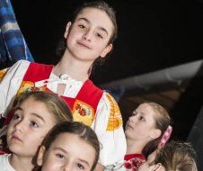 A group of young girls are standing next to each other.