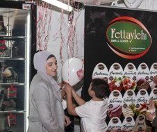 A woman and a child are playing with balloons in a store.